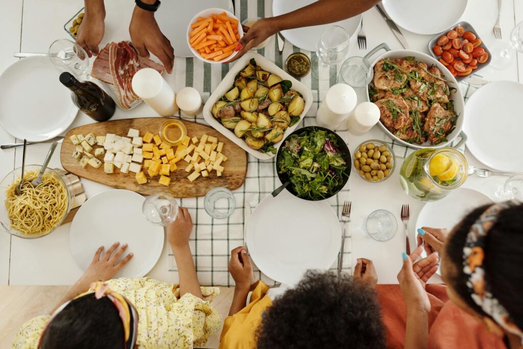 people around a table with food